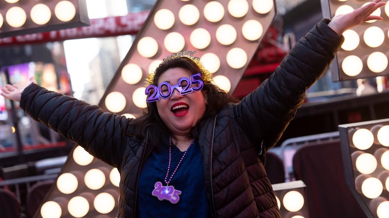 Teresa Hui poses in front of the 2025 New Year's Eve numerals in Times Square, Wednesday, Dec....