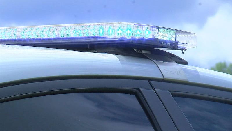 An Alabama State Trooper patrol car with its lights activated.