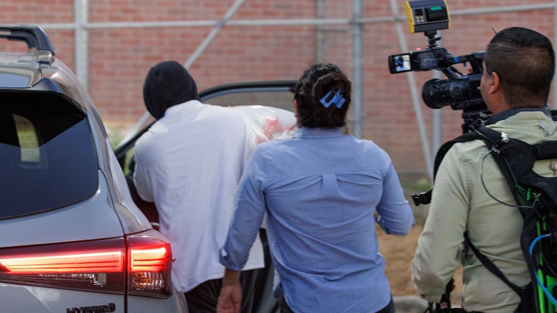 Immigration and Customs Enforcement officer Christian Castro gets into a car surrounded by...