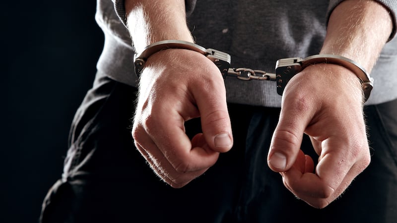 Offender with his hands in handcuffs